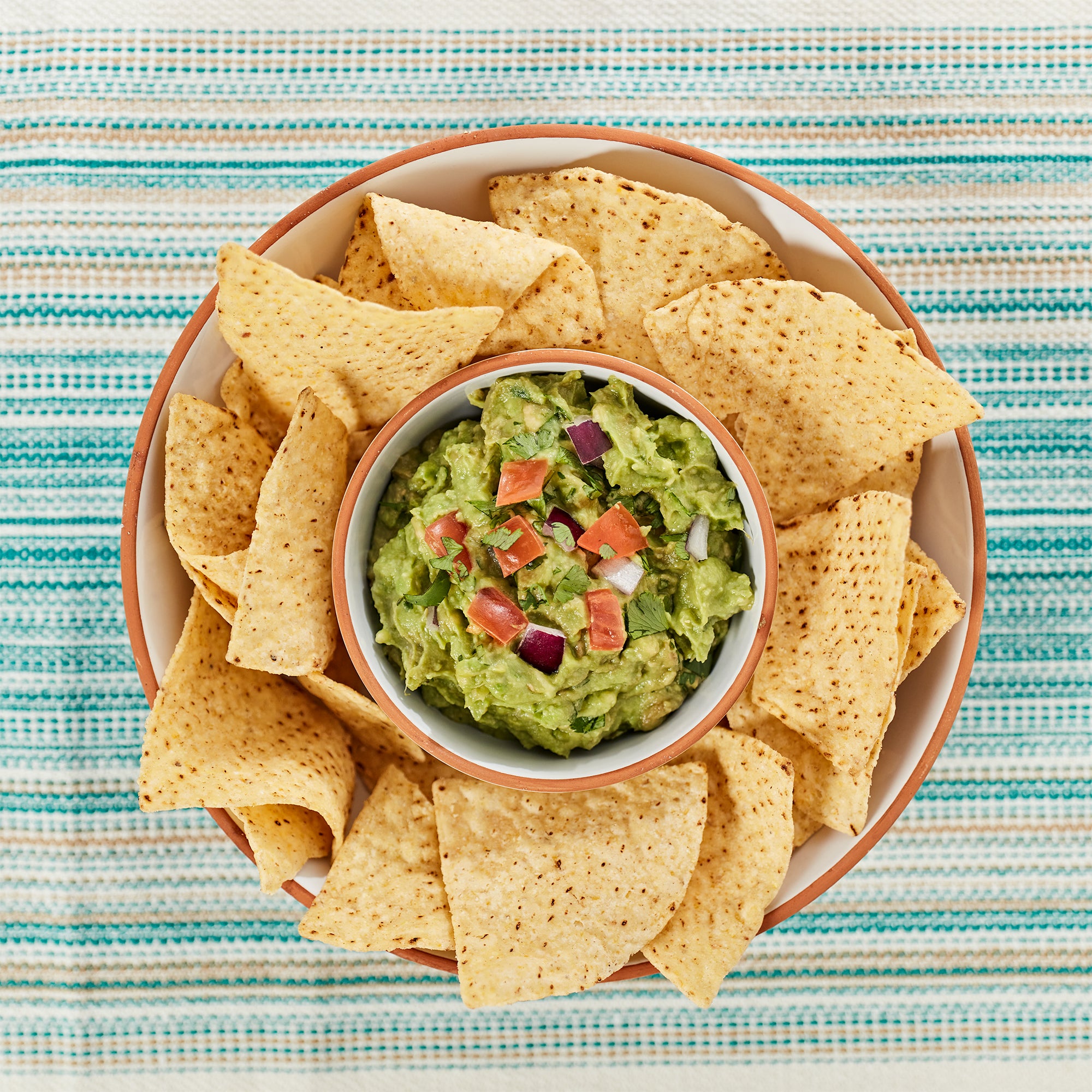 Infuse bold latin flavor chips and guacamole salsa platter serving tray bowl serving table setting